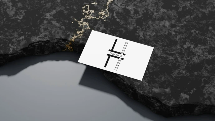 A business card sits on a textured surface.