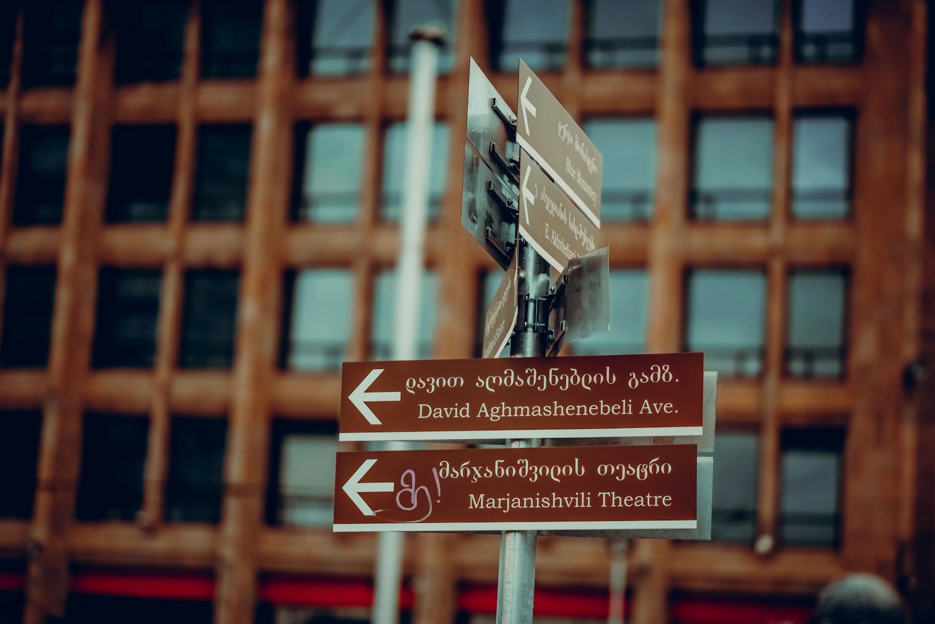 a street sign with a building in the background