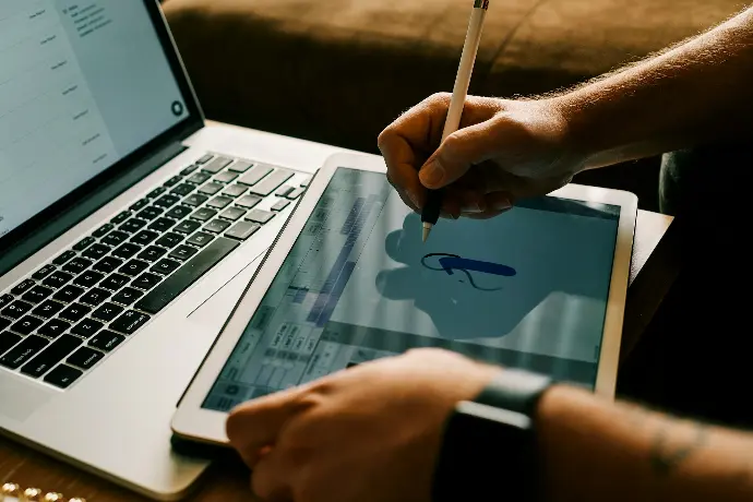 person writing on tab