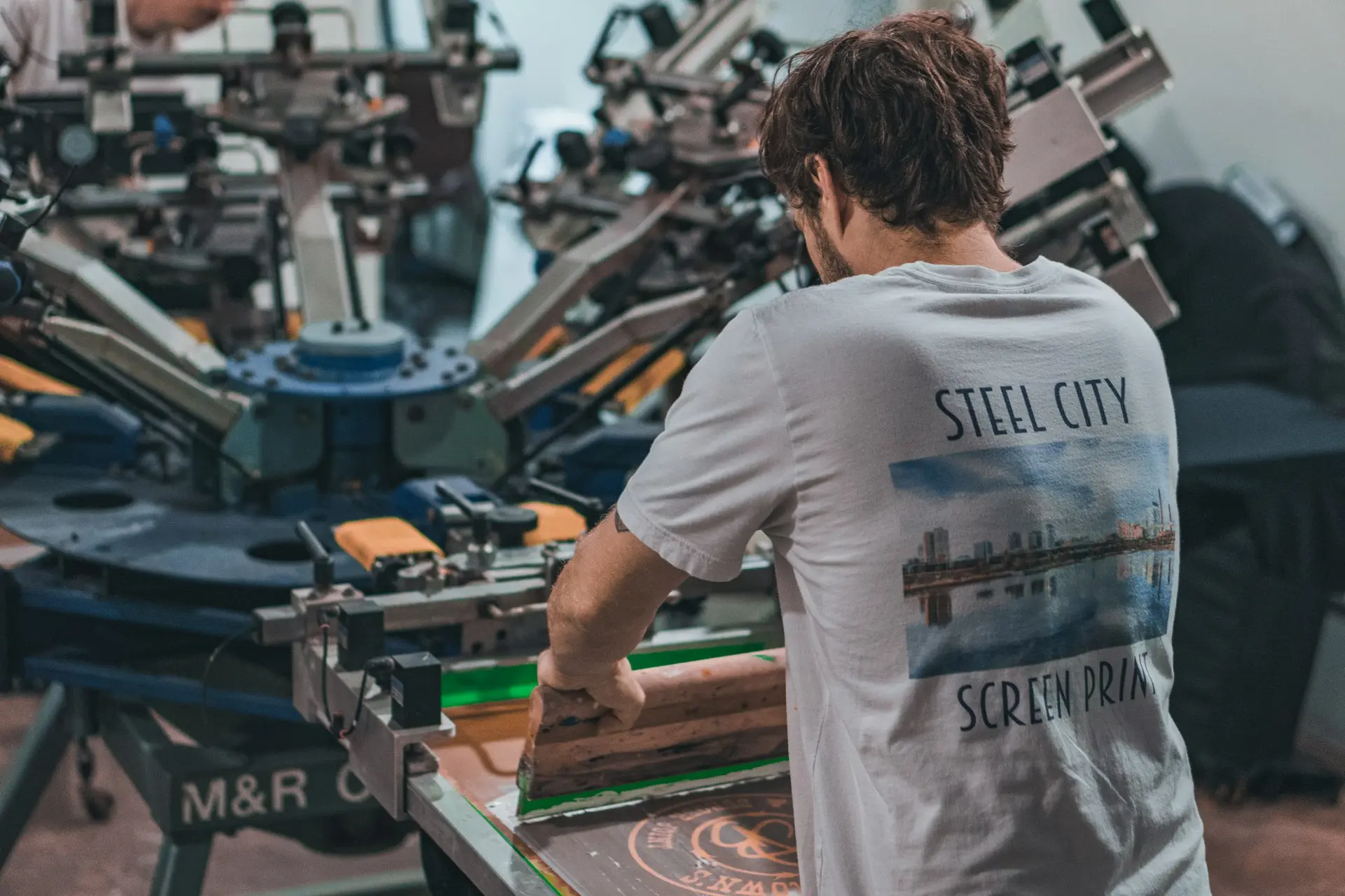 a screen printer working in a printing press