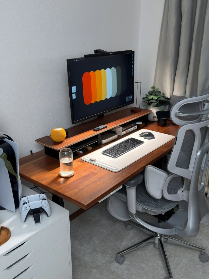 A modern desk setup with computer and gaming console.
