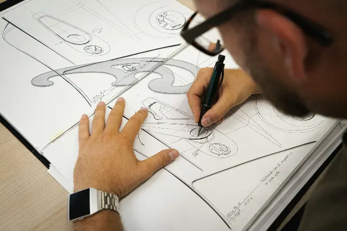 person drawing on white paper